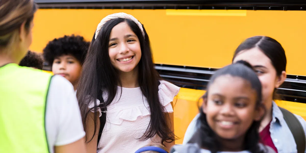 Students waiting to board the school bus
