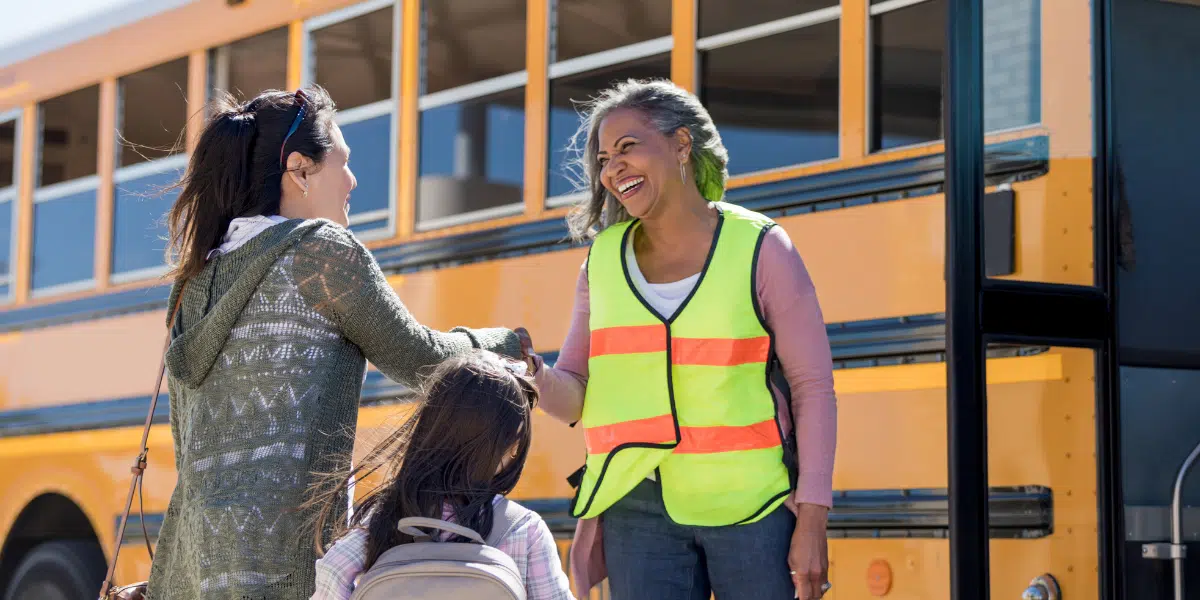 Bus Driver Greeting Parent and Child